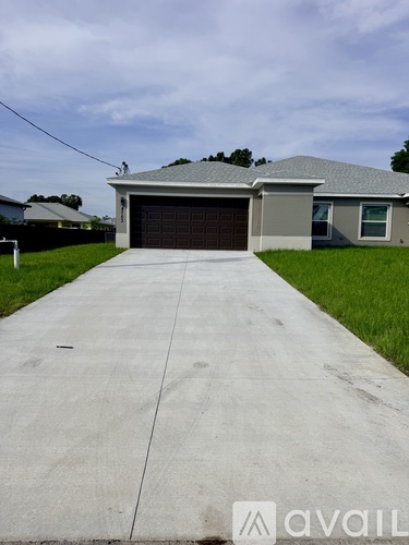A house with a grey roof and a garage door is shown.