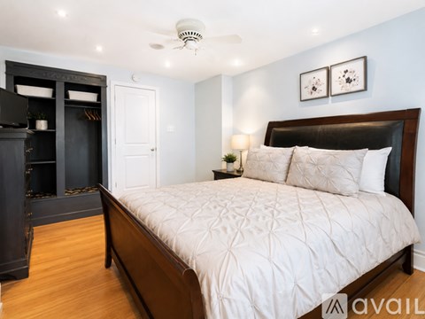 A bedroom with a large bed and a fireplace.