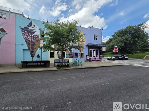A wall with a large ice cream cone mural on the side of a building.