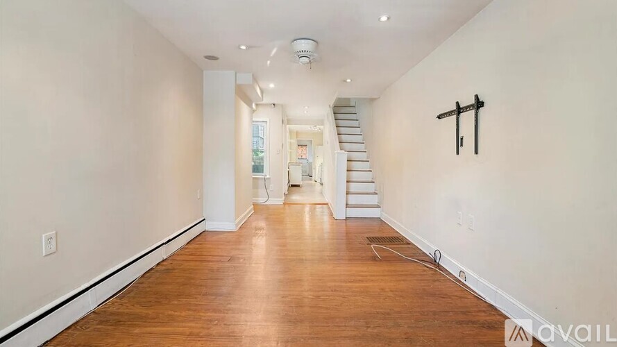 A long hallway with a staircase in the distance.