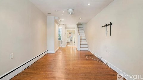 A long hallway with a staircase in the distance.