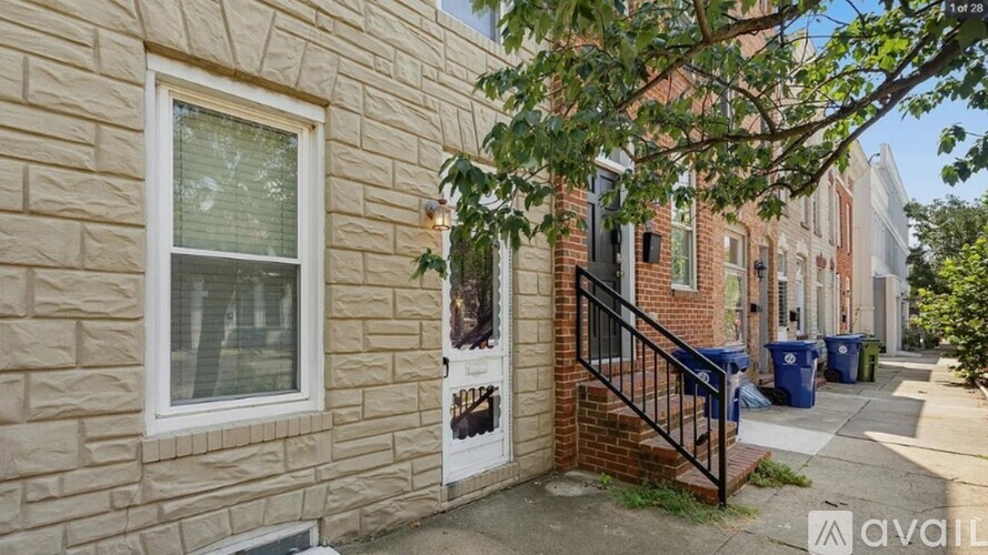 A house with a brick wall and a white window.