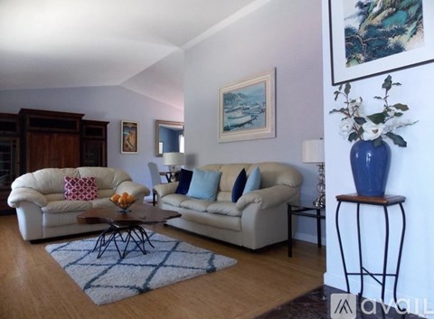 A living room with a white couch and a coffee table.