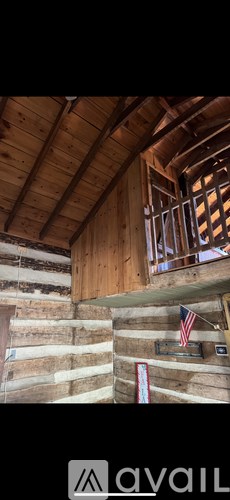 A wooden cabin with a flag on the wall.