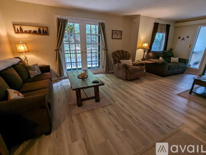 A living room with wooden floors and furniture.