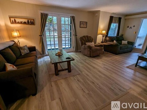 A living room with wooden floors and furniture.