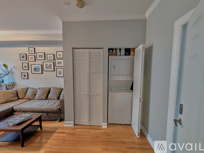A living room with a couch, coffee table, and pictures on the wall.