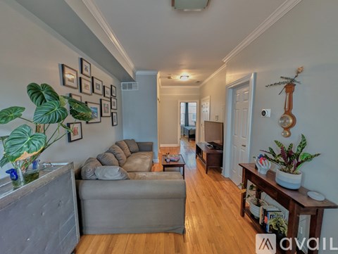 A living room with a grey couch and a wooden table.