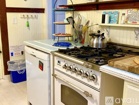 A kitchen with a white oven and a white stove top.