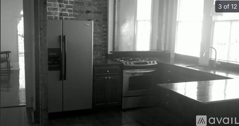A kitchen with a refrigerator, oven, and sink.
