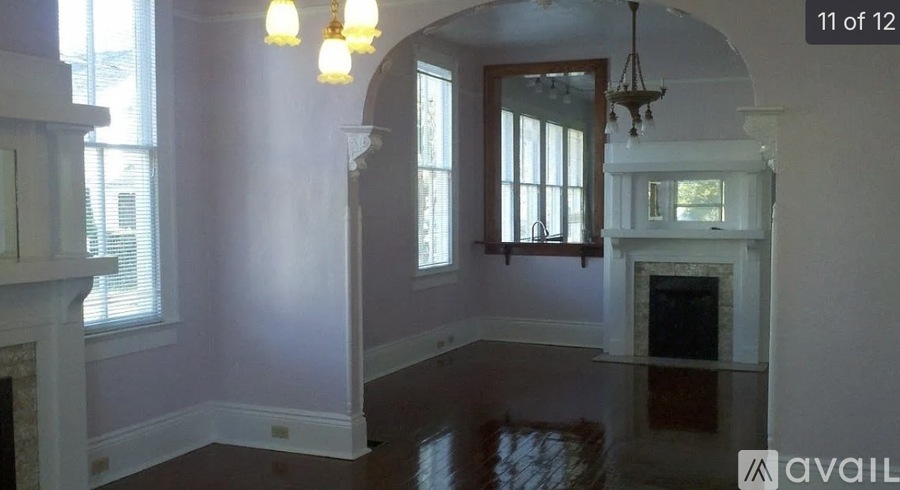 A room with a fireplace and a window.