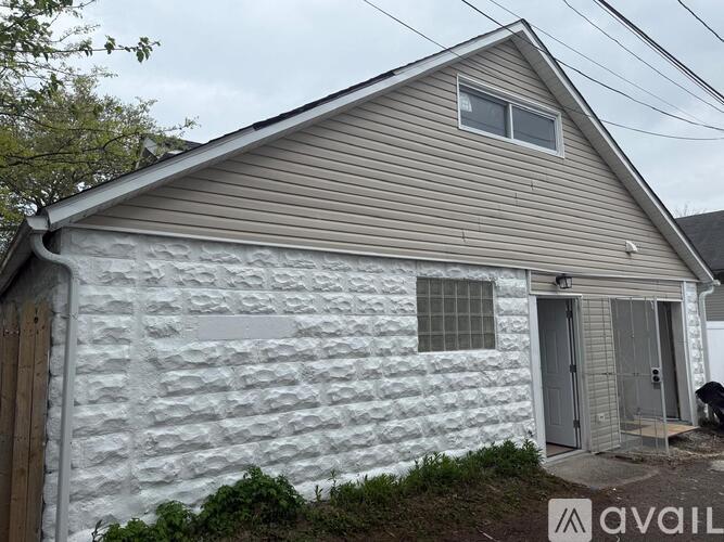 A small house with a grey door and windows is available for purchase.
