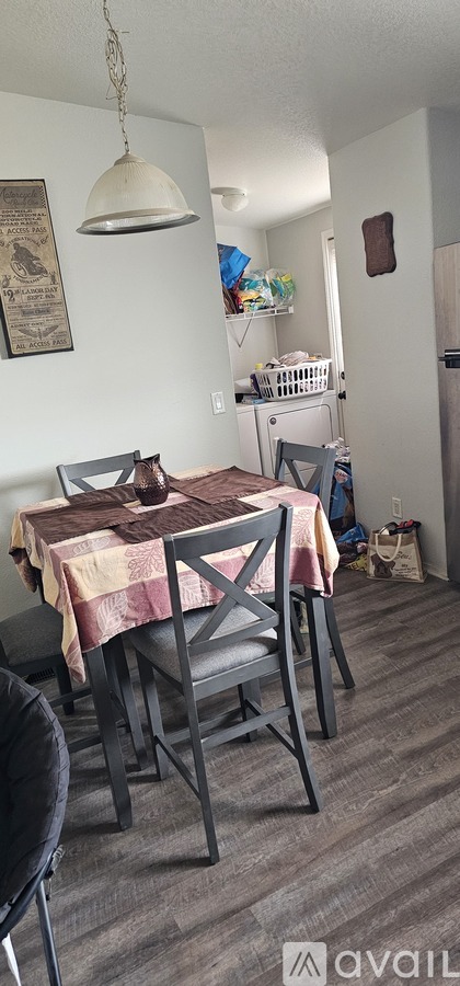 A dining room with a table and chairs.