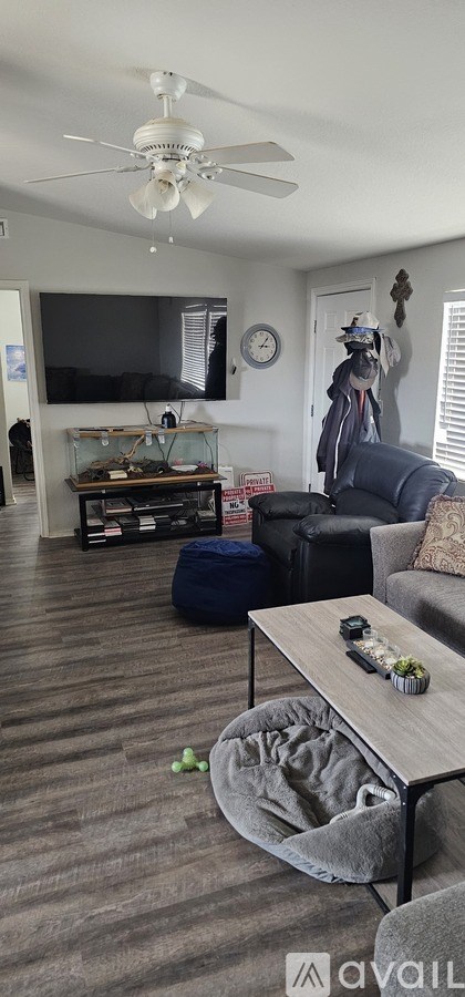 A living room with a grey couch and a coffee table.