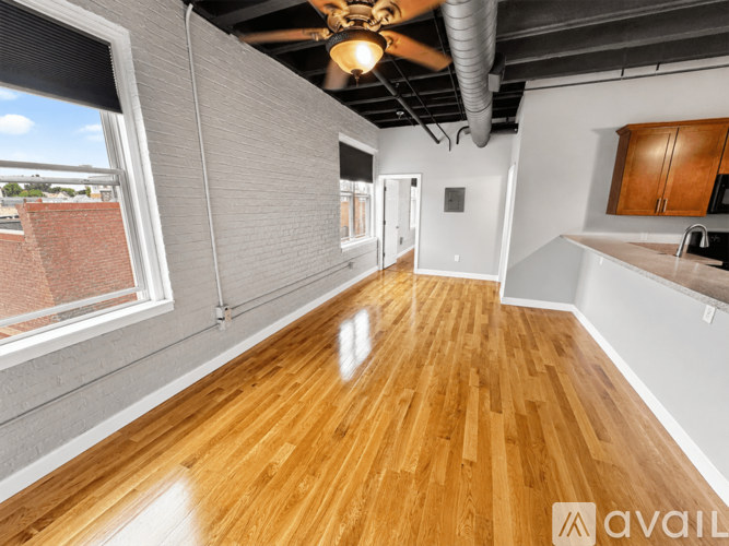 A room with wooden floors and a ceiling fan.