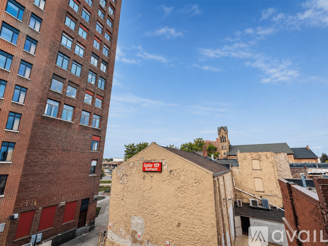 A tall red brick building with many windows is in the background.