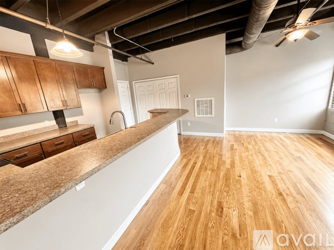 A kitchen with wooden floors and a countertop.