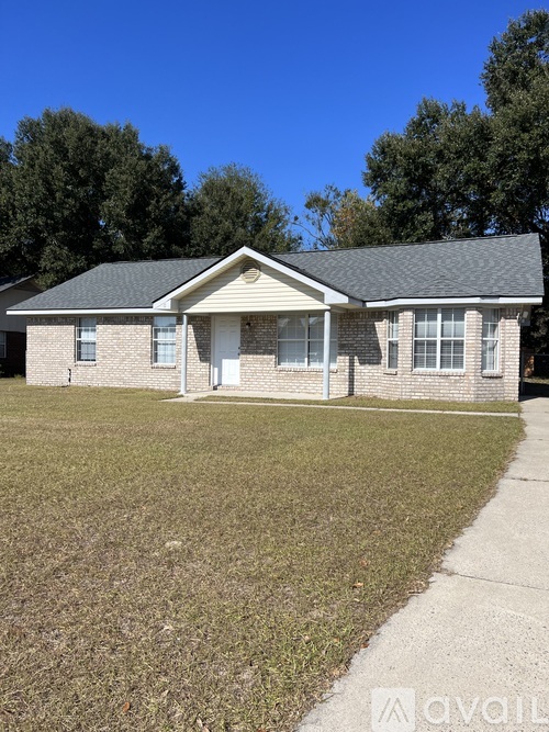 A house with a front yard and a driveway.