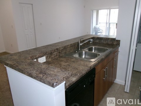 A kitchen with granite countertops and stainless steel appliances.