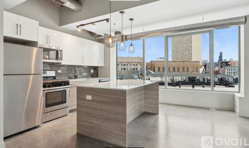 A modern kitchen with stainless steel appliances and a wooden island.
