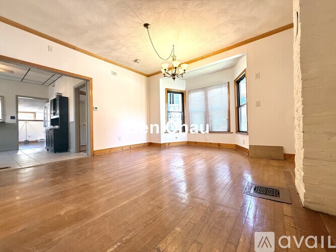 A room with wooden floors and a chandelier.