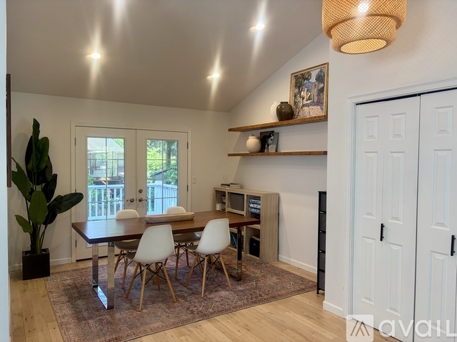 A dining room with a table and chairs.