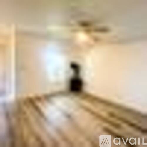 A blurry image of a person walking in a hallway.