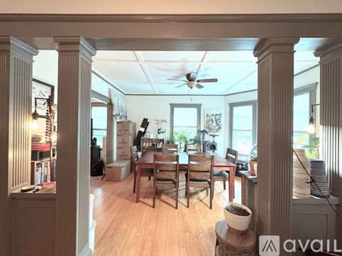 A living room with a dining table and chairs.