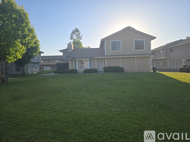 A house with a large lawn in front of it.
