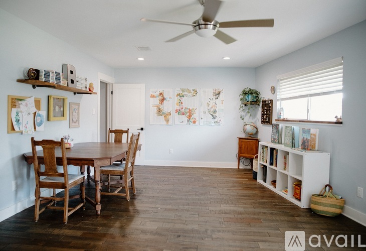 A dining room with a wooden table and chairs.