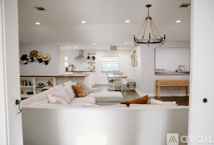 A bedroom with a large bed and a chandelier.