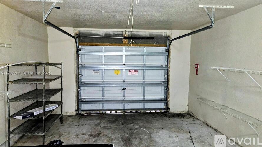 A storage room with a closed white door and shelves on the left.