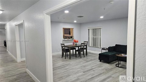 A living room with a dining table and chairs.
