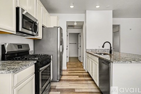 A kitchen with white cabinets and stainless steel appliances.