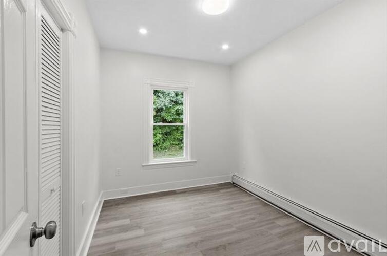 A room with a window and a door.