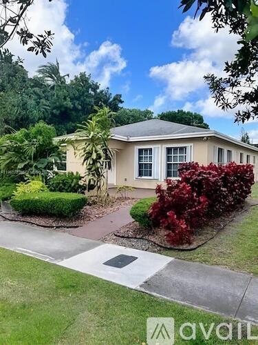 A house with a well-maintained lawn and garden in front.