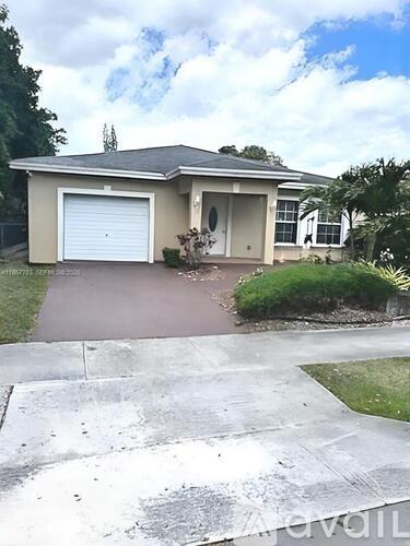 A house with a white garage door and a brown driveway.