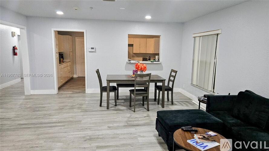 A living room with a dining table and chairs.