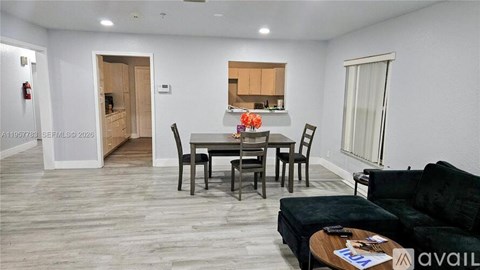 A living room with a dining table and chairs.