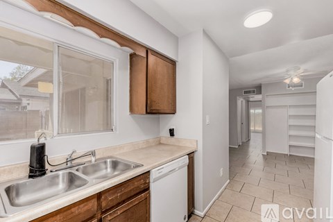 A kitchen with a sink and a window.