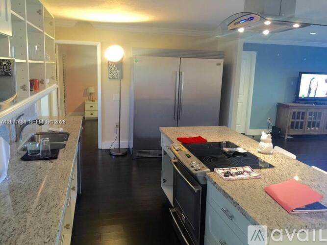 A kitchen with granite countertops and stainless steel appliances.