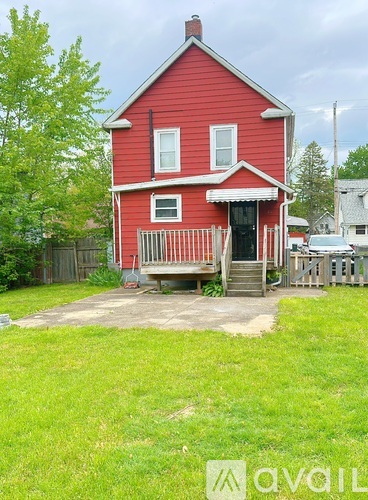 A red house with a white door and windows.