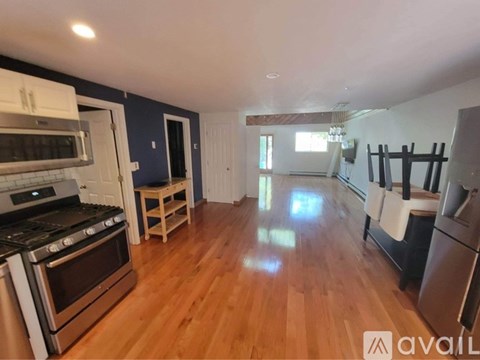 A kitchen with a stove top oven and a refrigerator.