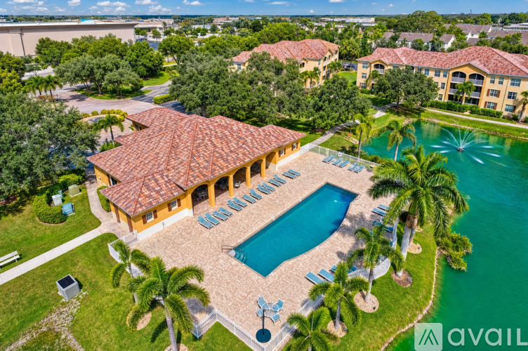 A large building with a pool in front of it.