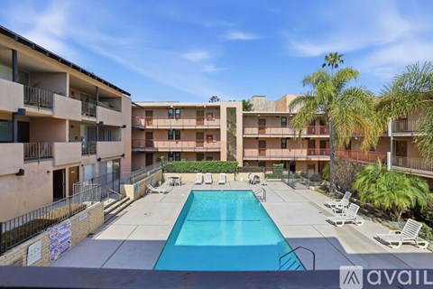 A pool in front of apartment buildings.