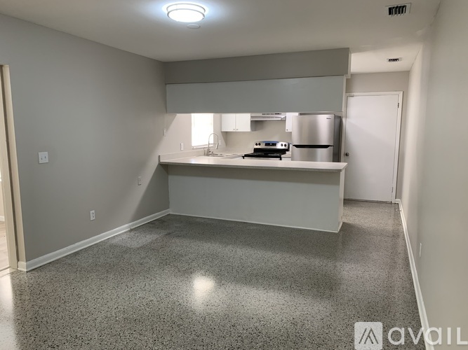A kitchen area with a countertop and a refrigerator.