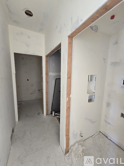 A room under construction with a wooden frame on the wall.