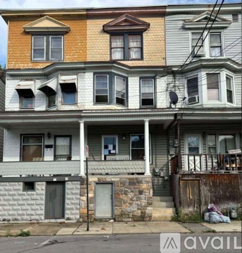 A row of houses with boarded up windows.