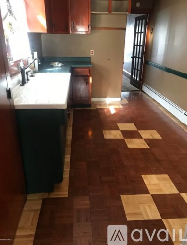 A kitchen with a checkerboard floor pattern.