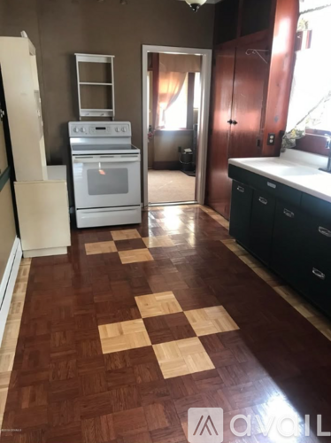 A kitchen with a checkerboard floor.